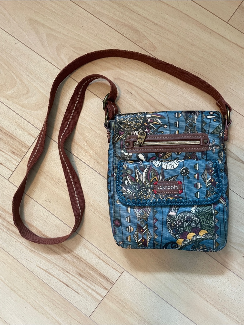 Sakroots Teal “Peace Print” Crossbody Bag with Brown Strap